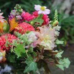 Bright and bold florist’s choice bouquet with seasonal flowers in orange, pink, and yellow tones