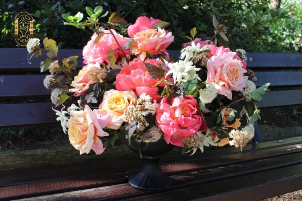 Coral peony and peach rose bouquet with burgundy fillers