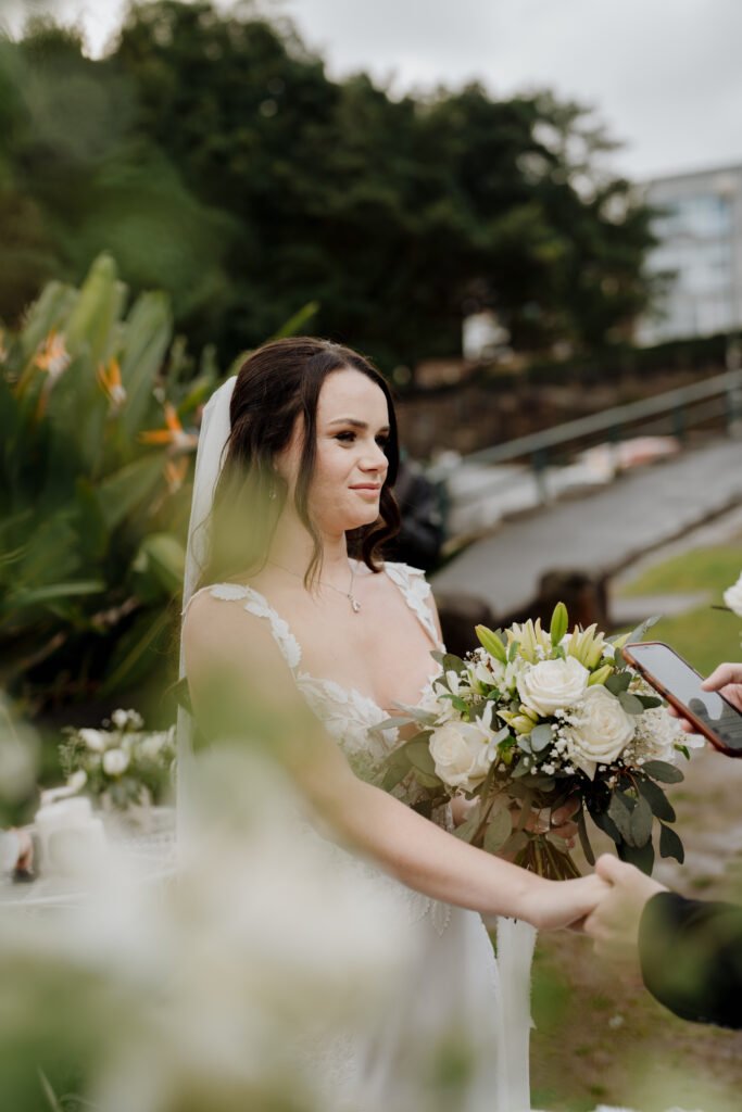 Elegant white and green bridal bouquet with roses and seasonal blooms by Sydney wedding florist