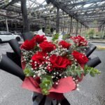Red rose bouquet with baby’s breath and eucalyptus foliage