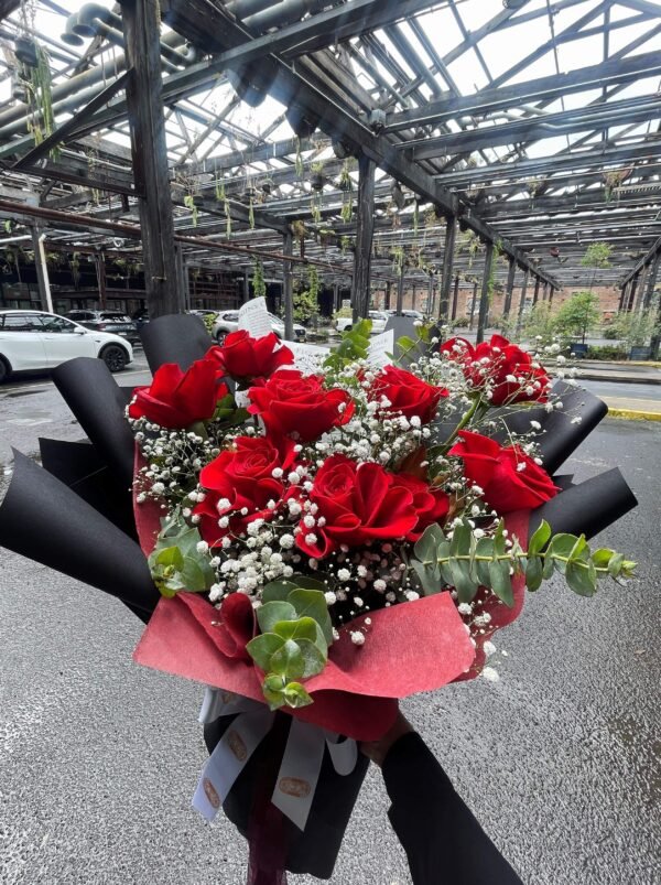 Red rose bouquet with baby’s breath and eucalyptus foliage