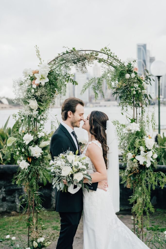 Elegant wedding ceremony flowers in Sydney with floral arch and aisle arrangements